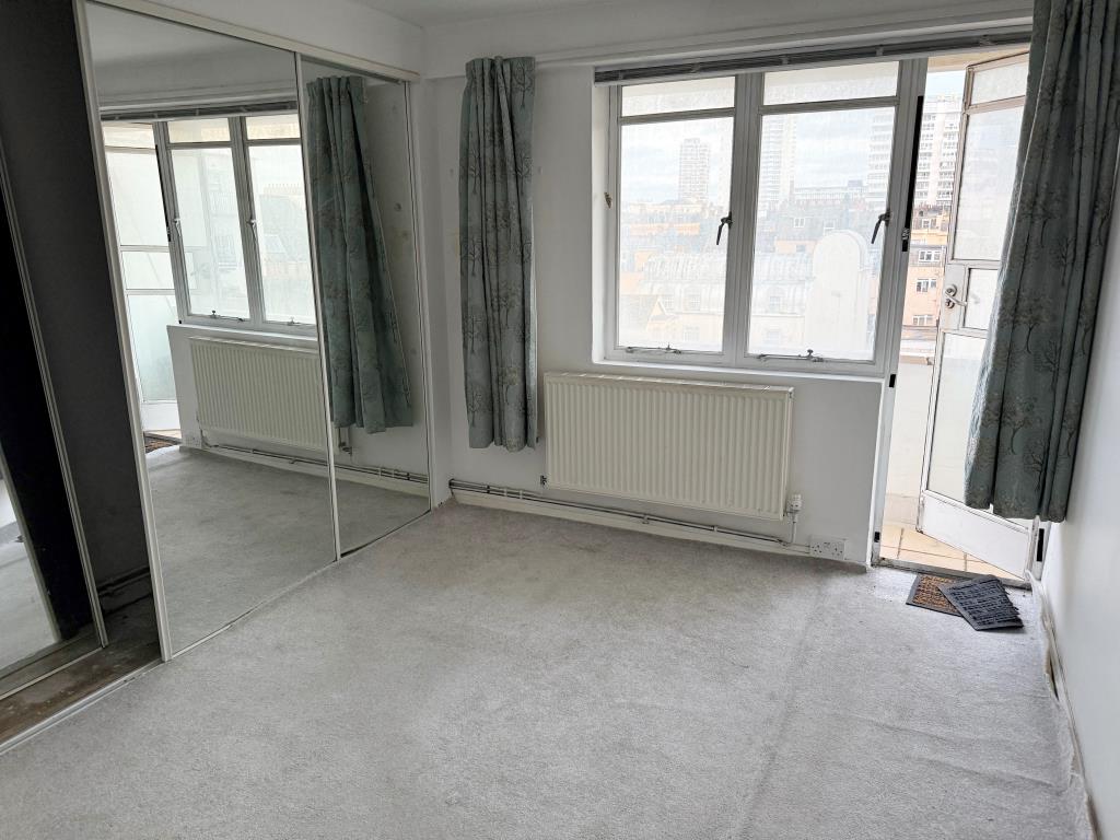 Lot: 87 - BALCONY FLAT IN NEED OF UPDATING - Living room with glazed door to balcony